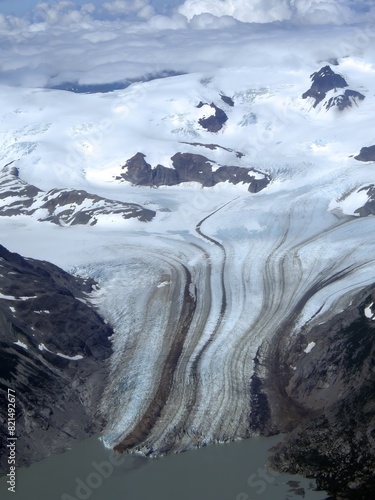 view of tidewater glacier and snowy mountain peaks  on a sunny summer day while flying to chinitna bay in lake clark national park, near homer , alaska      