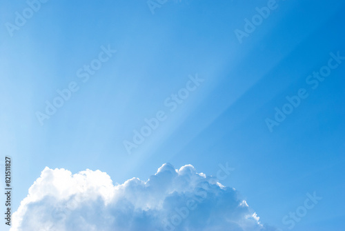 sun rays from a fluffy cloud