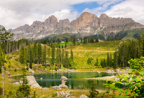 Landscape of Lake Carezza or Karersee and Dolomites in background