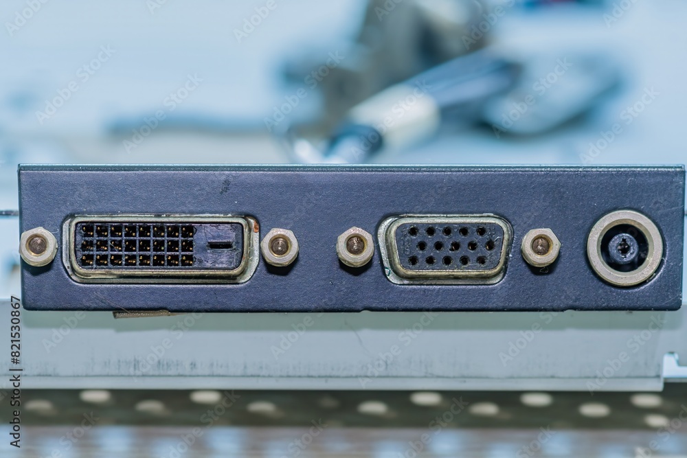 Close-up of computer ports on a metallic panel including VGA, DVI, and an power jack.