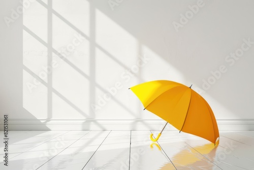 Open yellow umbrella on the clean white floor in the room
