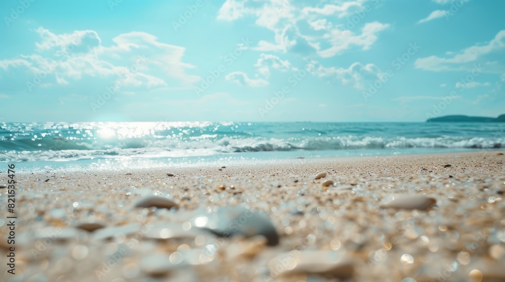 A tranquil beach scene with sun glinting off the sea, clear blue sky and waves gently breaking on the sandy shore A tranquil beach scene with sun glinting off the sea, clear blue sky and waves gently breaking on the sandy shore