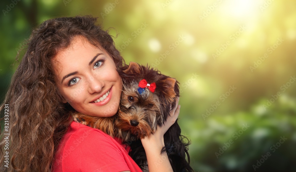 Young happy woman playing with dog in park. Young happy woman playing with dog in park.