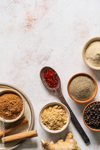 Ground spices in bowls on a neutral background background