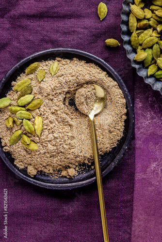 Ground cardamom in a blue bowl photo