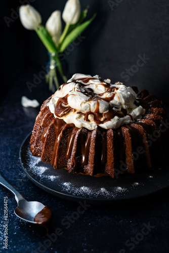 caramel bundt cake in a dark setting with florals