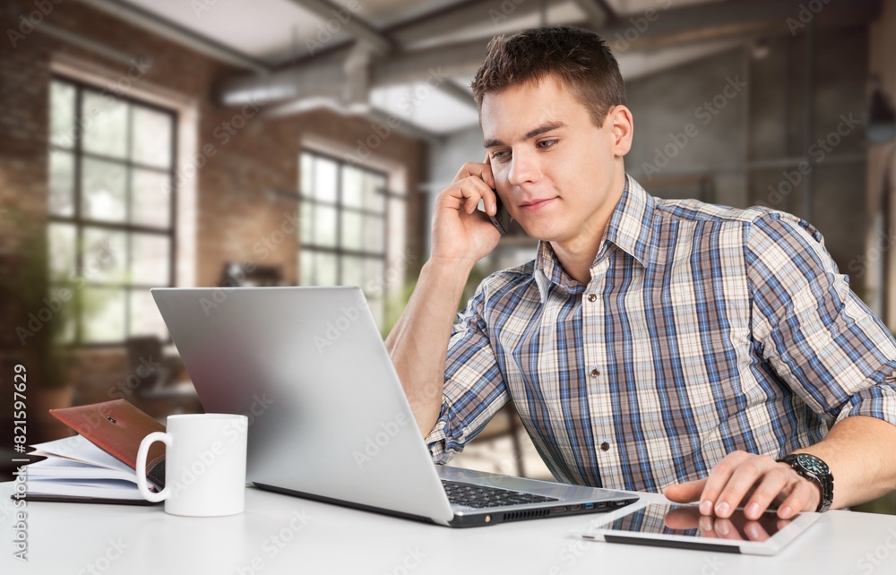 Smiling busy business man analyzing finance at office Smiling busy business man analyzing finance at office
