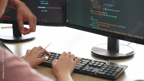 Slow motion back end or software developer manager supervising his team on new application program development on debugging and solving complex code algorithms on monitor. Burgeoning photo