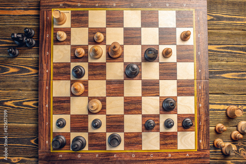 A wooden chessboard with pieces