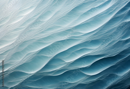 Abstract image of ocean waves with a smooth, layered appearance in shades of blue and white.