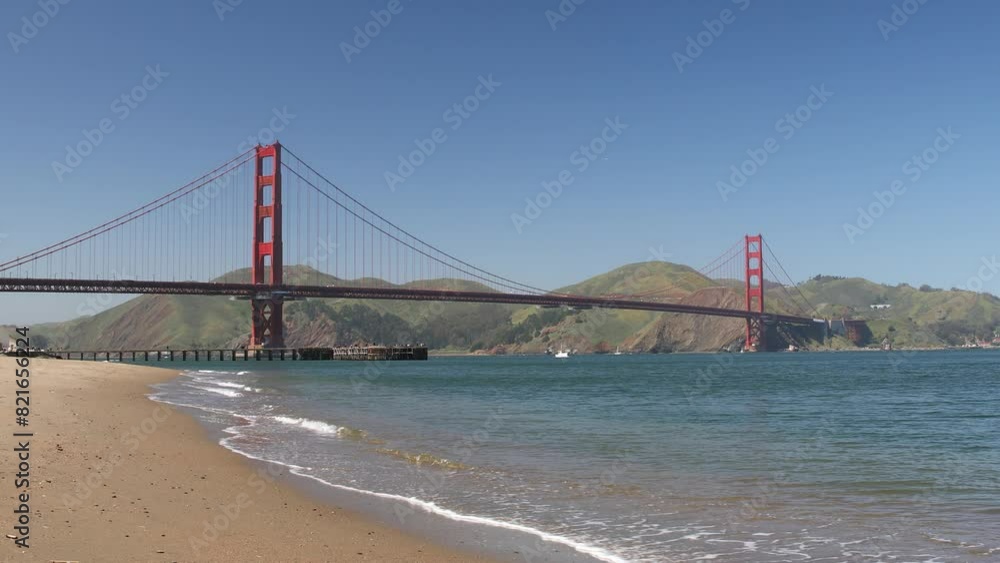Golden Gate Bridge with Blue Skies and Calm Beach Waters Across the Bay of San Francisco, California, USA. Golden Gate Bridge with Blue Skies and Calm Beach Waters Across the Bay of San Francisco, California, USA.
