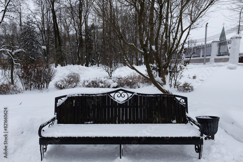 snowy bench in the park photo