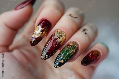Woman's beautiful hand with long nails and bright manicure with bottles of nail polish