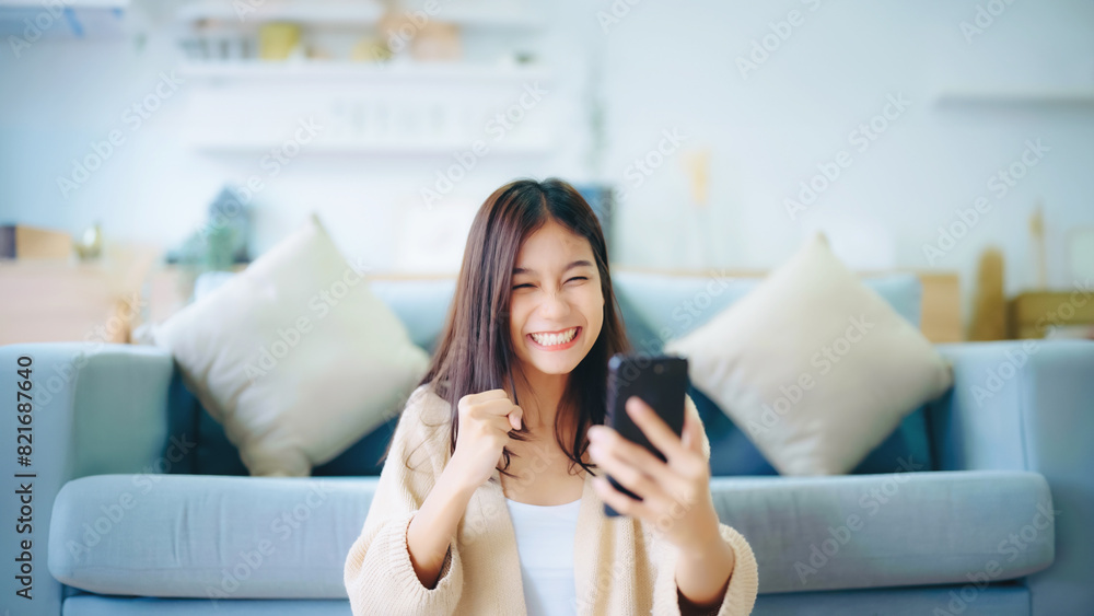 Happy young asian woman relax on comfortable couch at home texting messaging on smartphone, smiling girl use cellphone, chatting online message, shopping online from home Happy young asian woman relax on comfortable couch at home texting messaging on smartphone, smiling girl use cellphone, chatting online message, shopping online from home