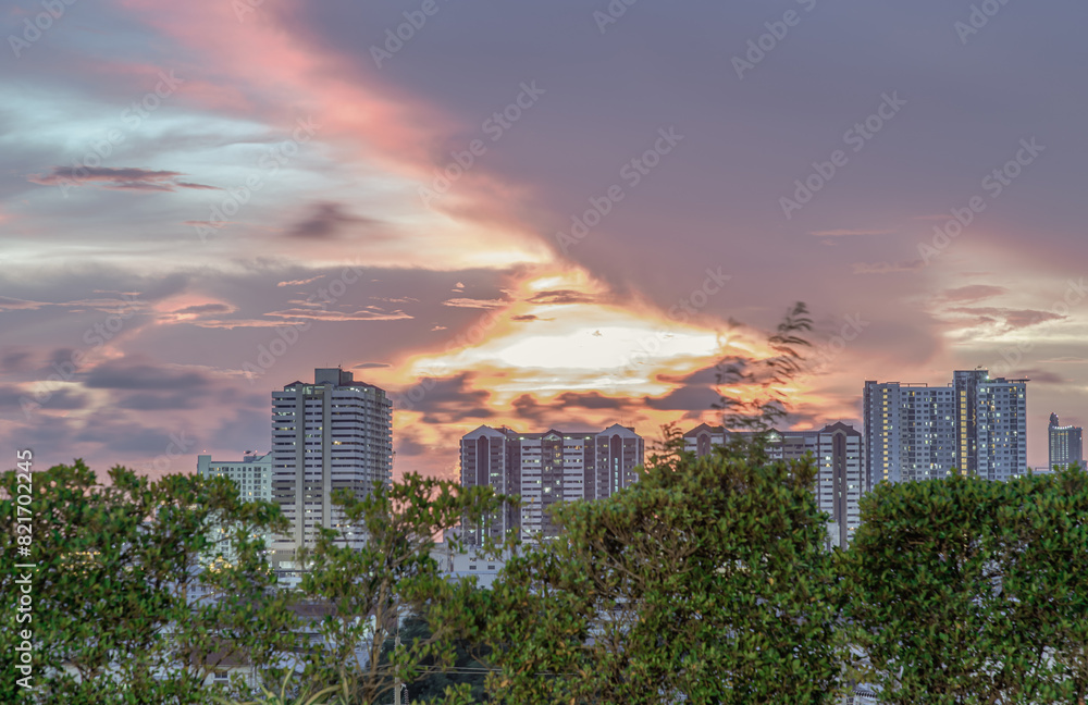 Fototapeta premium Gorgeous scenic of sunset with beautiful cloud and sky over metropolitan city. Bangkok city skyscrapers after sunset with Beautiful sky background, They can be used as Wallpaper, Copy space.