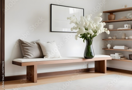 A minimalist living room with white sofa  a wooden coffe table  and a large framed blank wall art. 3D Rendering