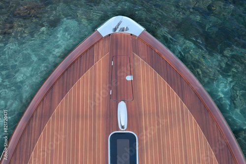 Front part of a wooden Luxury boat top view against a background of azure water. Top view of the deck of a wooden expensive exclusive boat. Varnished wooden boat on an azure water background.