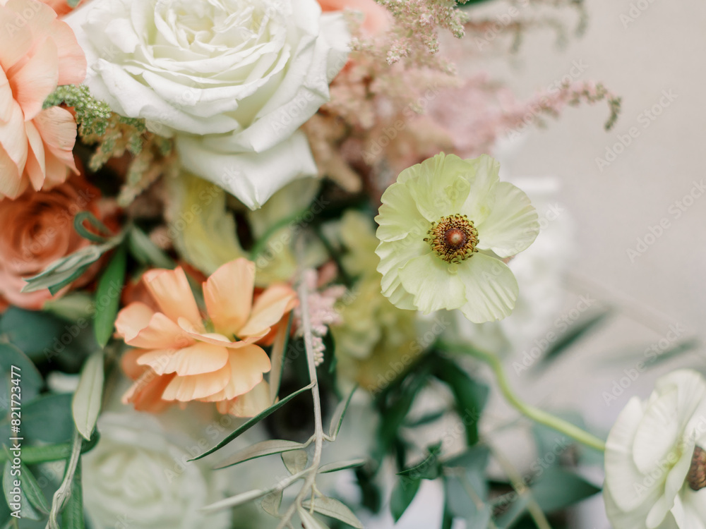 Elegant wedding bouquet with roses and vibrant anemones