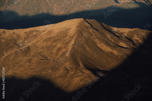 Autumn morning in mountains gold-lit shadow and light photo