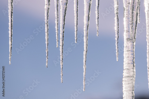 Close-up of icicles hanging against a clear winter sky