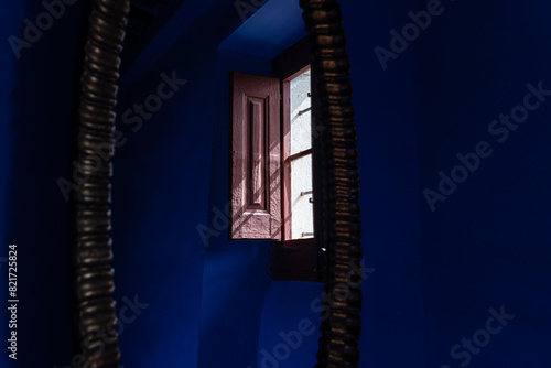 Vivid window in a shadowy blue room, with textured contrasts