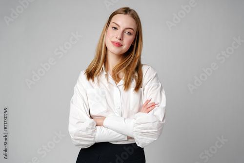 Joyful Young Blonde Woman Smiling against gray background