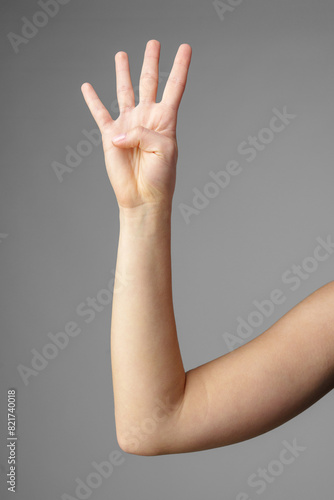 Woman Holding Arm Up in the Air with Gesture