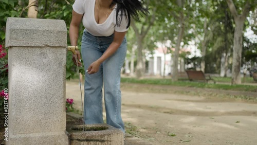 Voluptuous curvy woman drinking water from a fountain.MOV