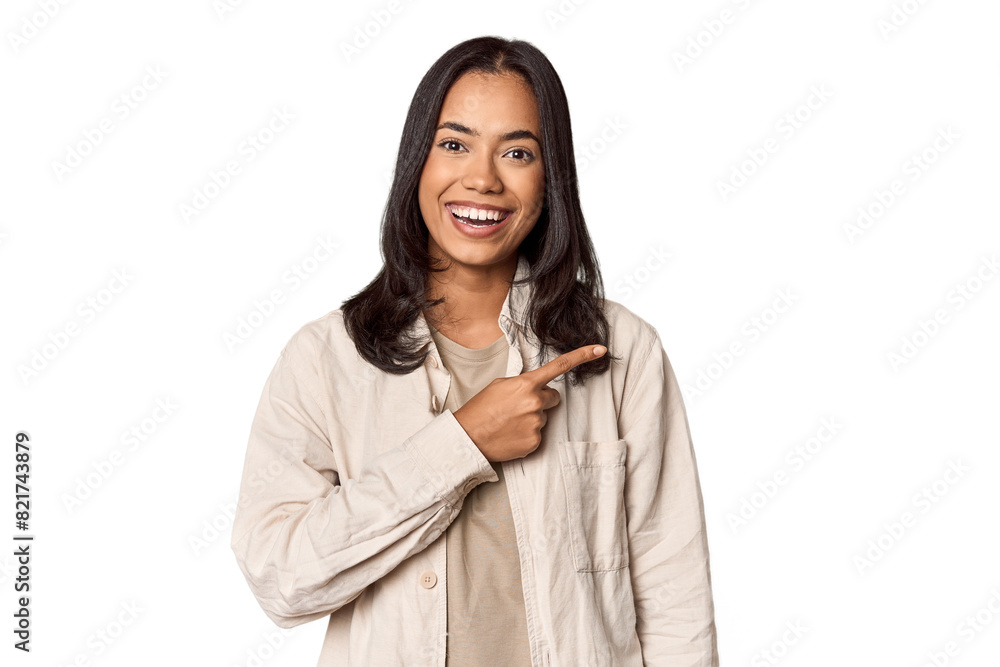 Portrait of a young Filipino woman smiling and pointing aside, showing something at blank space. Portrait of a young Filipino woman smiling and pointing aside, showing something at blank space.