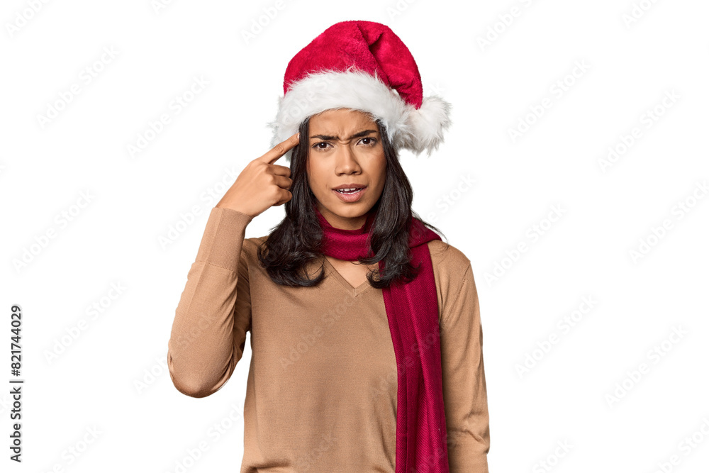 Filipino in Christmas attire and Santa hat showing a disappointment gesture with forefinger. Filipino in Christmas attire and Santa hat showing a disappointment gesture with forefinger.