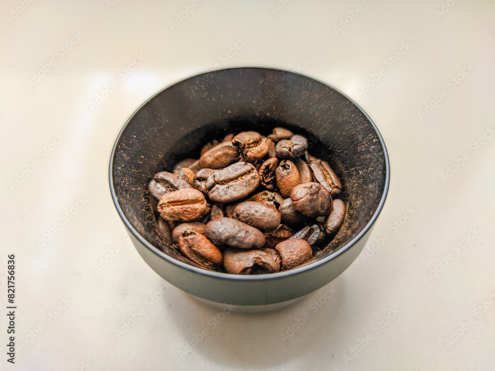 A captivating photo showcases coffee beans nestled within a dosing ring pressurized basket, ready for the perfect espresso extraction. A captivating photo showcases coffee beans nestled within a dosing ring pressurized basket, ready for the perfect espresso extraction.