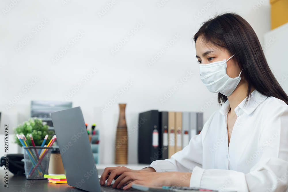 Asian businesswoman working at laptop in the office. Asian businesswoman working at laptop in the office.