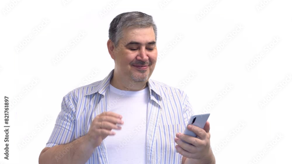 A man using a smartphone to have a video call. White background. A man using a smartphone to have a video call. White background.