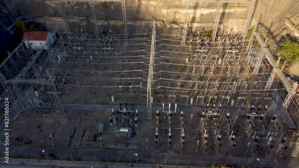 Aerial pull back over electricity substation in dam at sunset Aerial pull back over electricity substation in dam at sunset