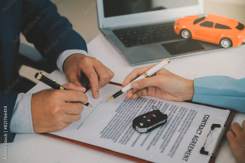 Insurance officers hand over the car keys after the tenant. have signed an auto insurance document or a lease or agreement document Buying or selling a new or used car with a car Insurance officers hand over the car keys after the tenant. have signed an auto insurance document or a lease or agreement document Buying or selling a new or used car with a car