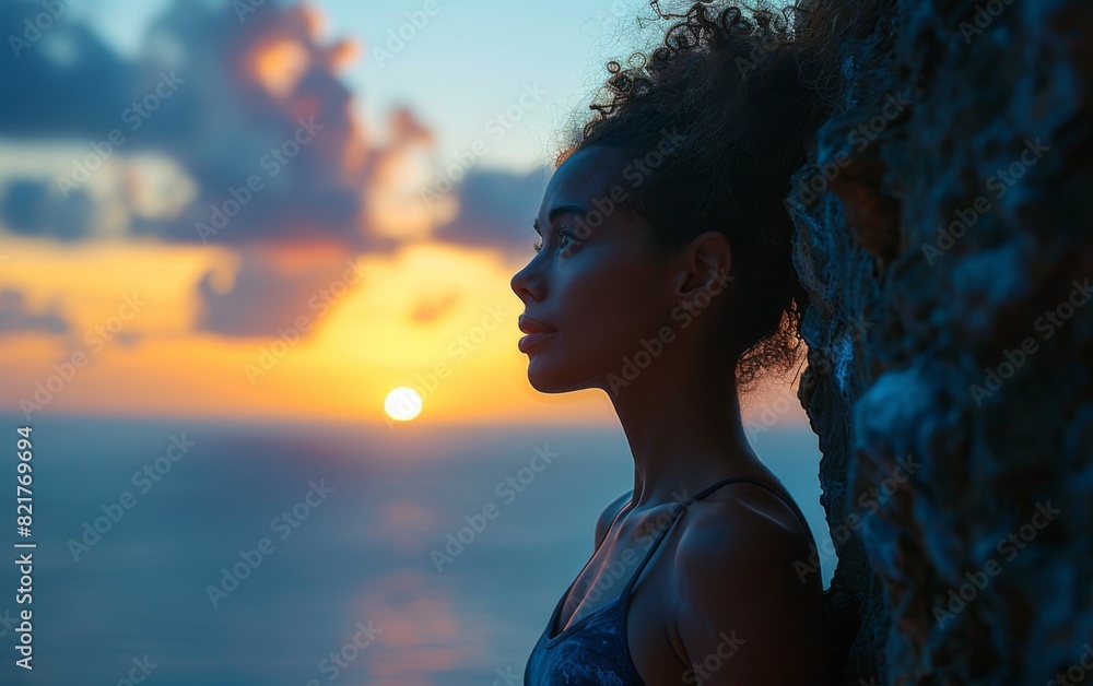 A woman of mixed race standing next to a tree on the shore of the ocean A woman of mixed race standing next to a tree on the shore of the ocean