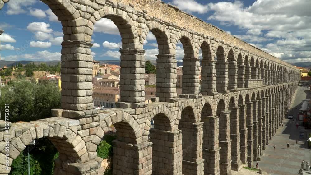 Ancient Roman aqueduct on Plaza del Azoguejo square and old building towns in Segovia, Spain