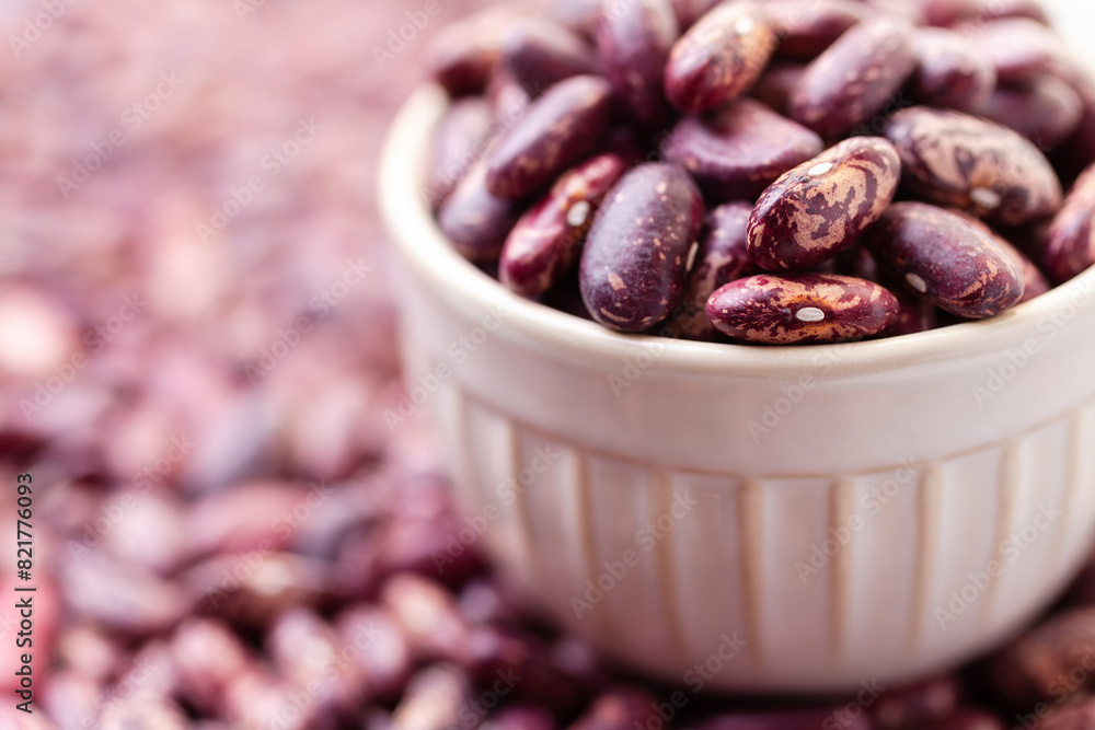 Uncooked variegated kidney bean seeds in bowl. Red and white dry beans Uncooked variegated kidney bean seeds in bowl. Red and white dry beans