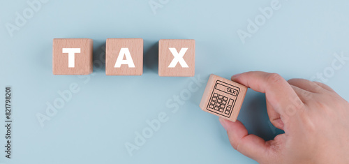 Tax with Saving Bank and wooden block cube concept, , tax payment optimisation business finance, wooden home  with taxes icon on technology screen, income tax and property, corporations such as VAT