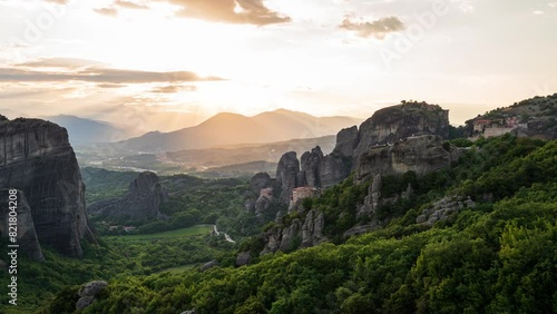 Astonishing view of Meteora valley at sunset with Rousanou nunnery, St Nicholaos Anapafsas monastery and Varlaam monastery near Kastraki, Greece. photo