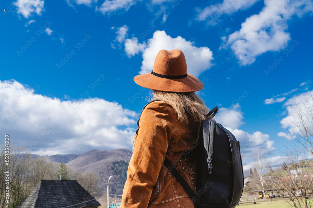 Woman wearing sun hat and looking at sky Woman wearing sun hat and looking at sky