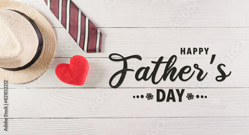 Happy Father's Day decoration with colorful tie with red heart and hat on white wooden background.