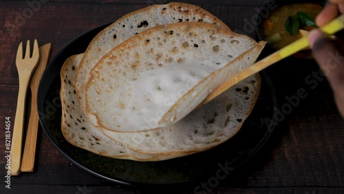 Aappam with Sambar on a wooden table. Appam or Palappam is one of the most popular and traditional breakfast in Kerala and South India. photo