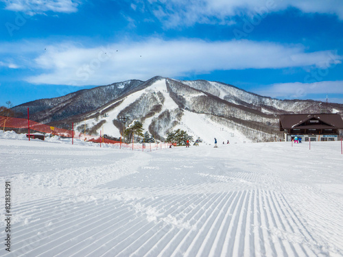 Freshly groomed snow slope on a sunny day (Madarao Kogen, Nagano, Japan)