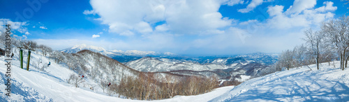 Panorama view of snow slopes from the summit on a sunny day (Madarao Kogen, Nagano, Japan) photo