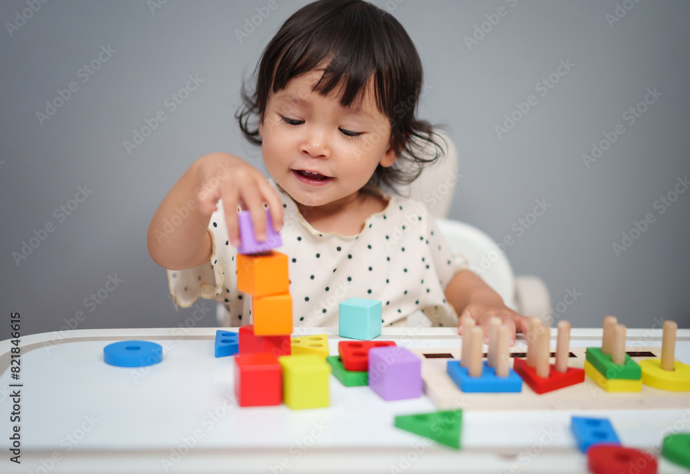 toddler baby playing block toy to stacks building cubes on table toddler baby playing block toy to stacks building cubes on table