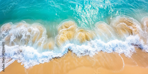 Aerial sandy beach waves from top view. Summer seascape and sea cost of turquoise ocean background from air. Panoramic tropical Mediterranean holiday summer vacation wide beach landscape concept image