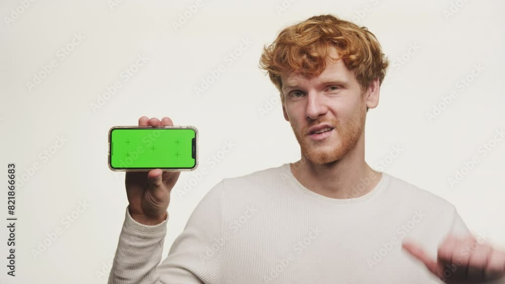 Man Holding Smartphone with Green Screen Thumbs Down Man Holding Smartphone with Green Screen Thumbs Down