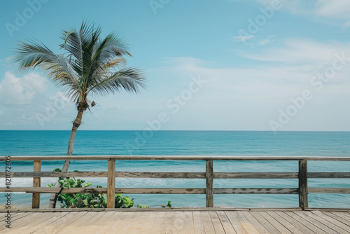 A palm tree stands on a weathered wooden deck under a clear sky