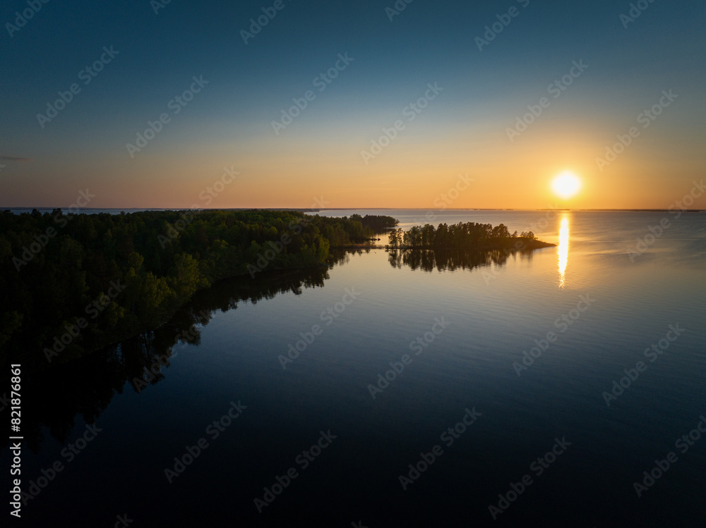 Scenic Aerial View of Reflecting Swedish Forest Lake During Sunset